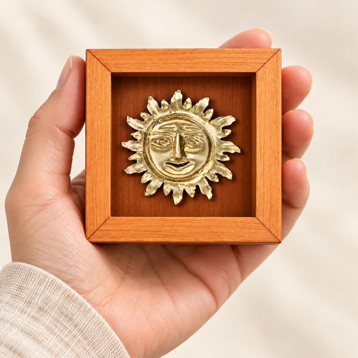 Inti Mini de 7 × 7 cm sostenido en una mano para apreciar su tamaño; representación digital de escala aproximada.