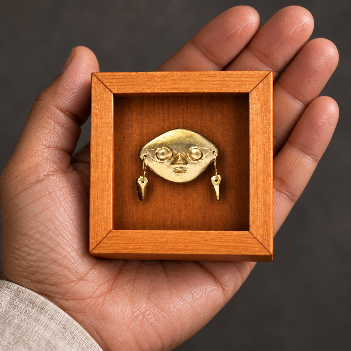 Sicán · Mini Shadow Box 7 cm en una palma para apreciar su escala: recreación digital del producto original.